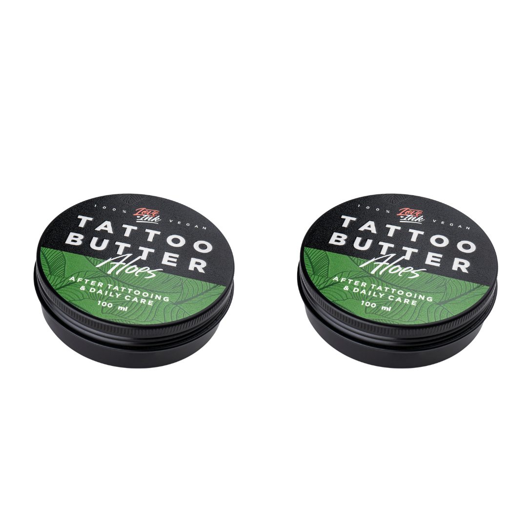 Two tins of Love Ink Tattoo Butter on a transparent background. Both tins are labeled 'Aloe' with a green design