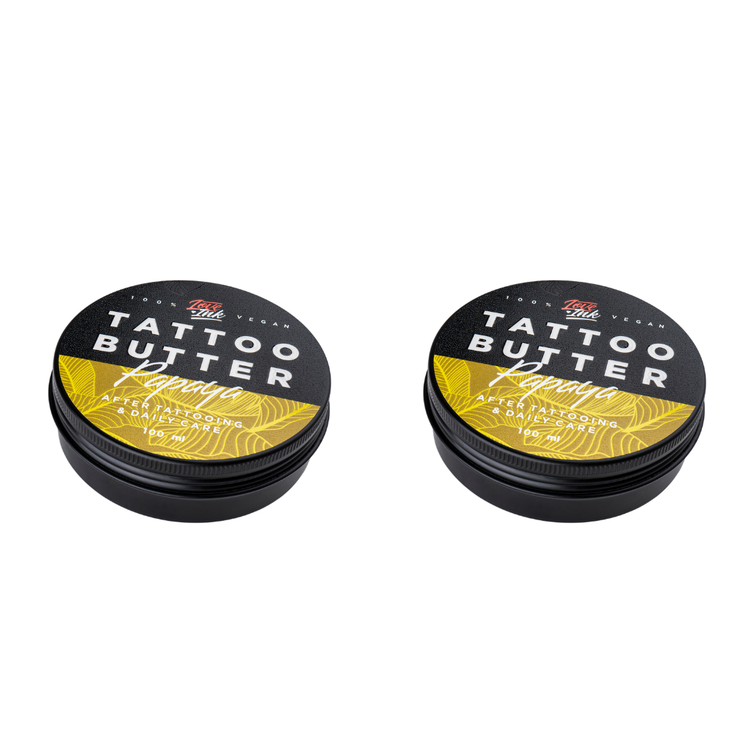 Two tins of Love Ink Tattoo Butter on a transparent background. Both tins are labeled 'Papaya " with an yellow design