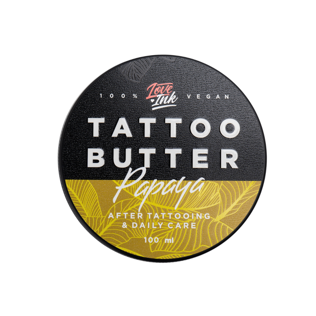 Top view of a 100ml jar of Tattoo Butter Papaya by LoveInk. The sleek black and yellow packaging highlights its purpose for after tattooing and daily care.