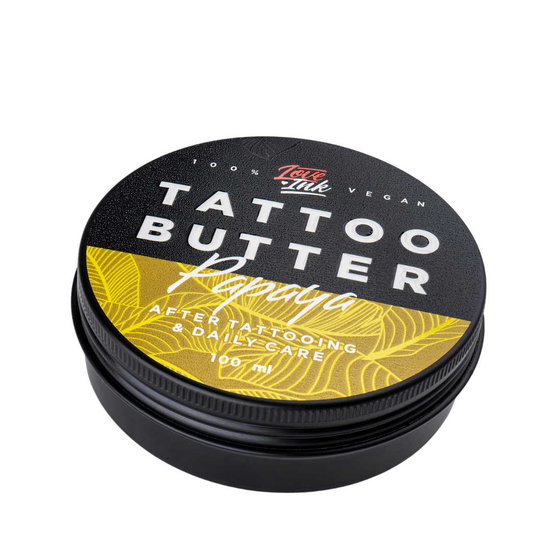 Close-up of a 100ml jar of Tattoo Butter Papaya by LoveInk. The product features a black and yellow design, emphasizing its use for after tattooing and daily care.